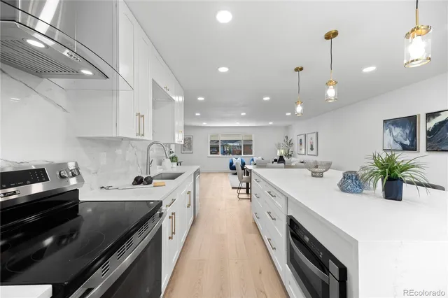 a kitchen with a sink stove and cabinets