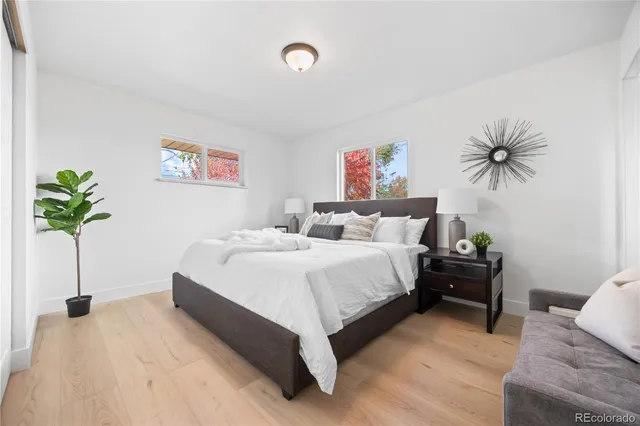 a bedroom with a bed and a potted plant