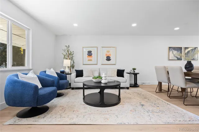 a living room with furniture a rug and a large window