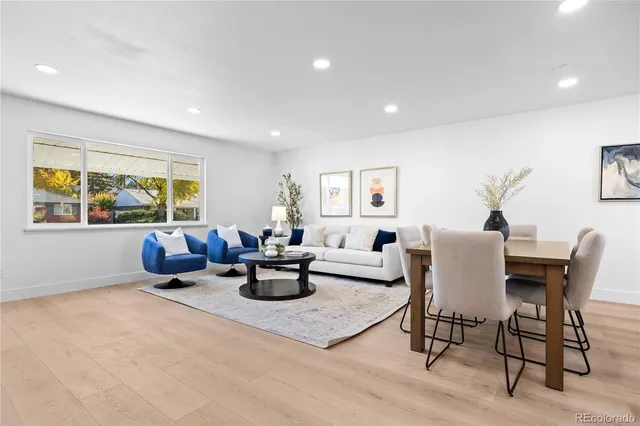 a living room with furniture a window and a table