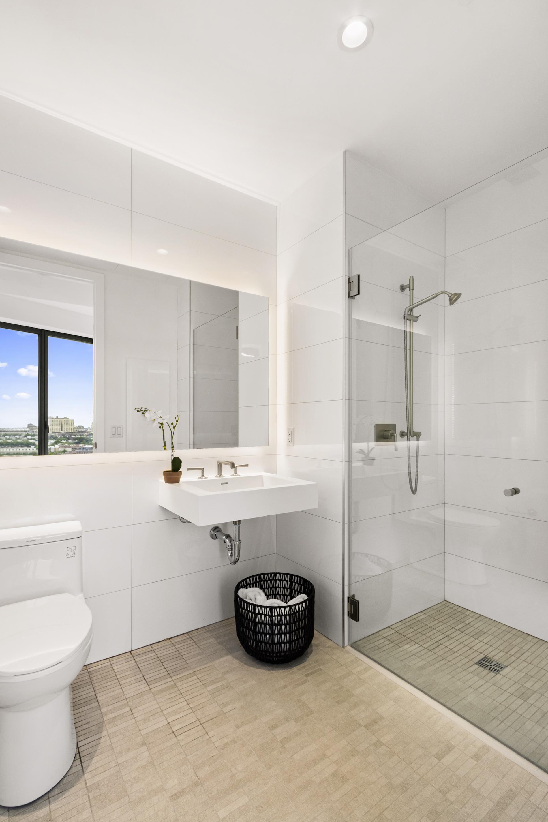 545 Vanderbilt Avenue, Unit PH3C Brooklyn, NY 11238 - Photo 5 of 16 a bathroom with a sink a toilet and shower