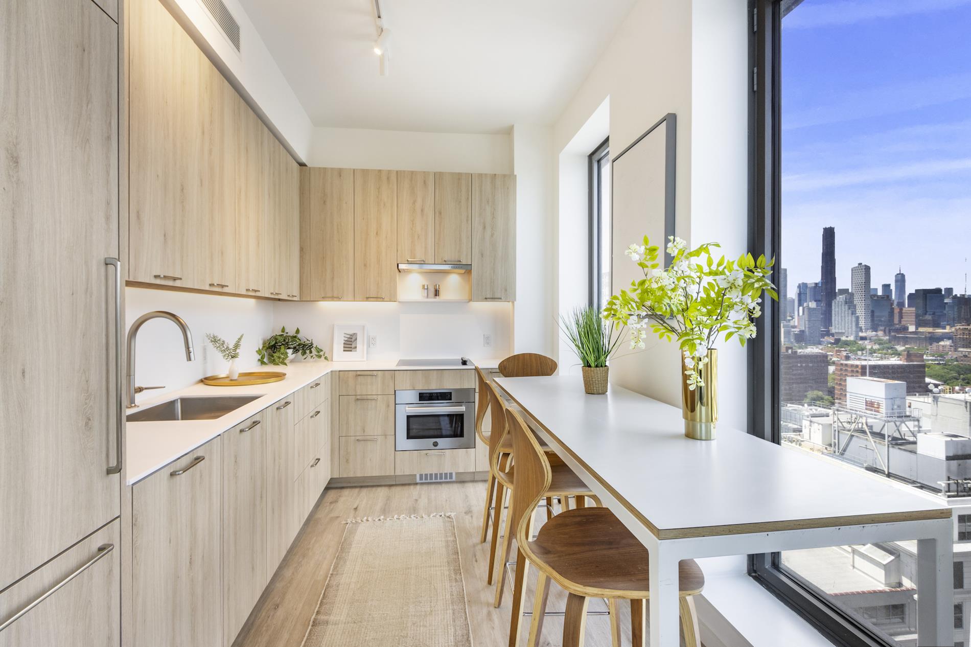 545 Vanderbilt Avenue, Unit PH3C Brooklyn, NY 11238 - Photo 6 of 16 a kitchen with stainless steel appliances a sink a counter top space cabinets a sink and a potted plant
