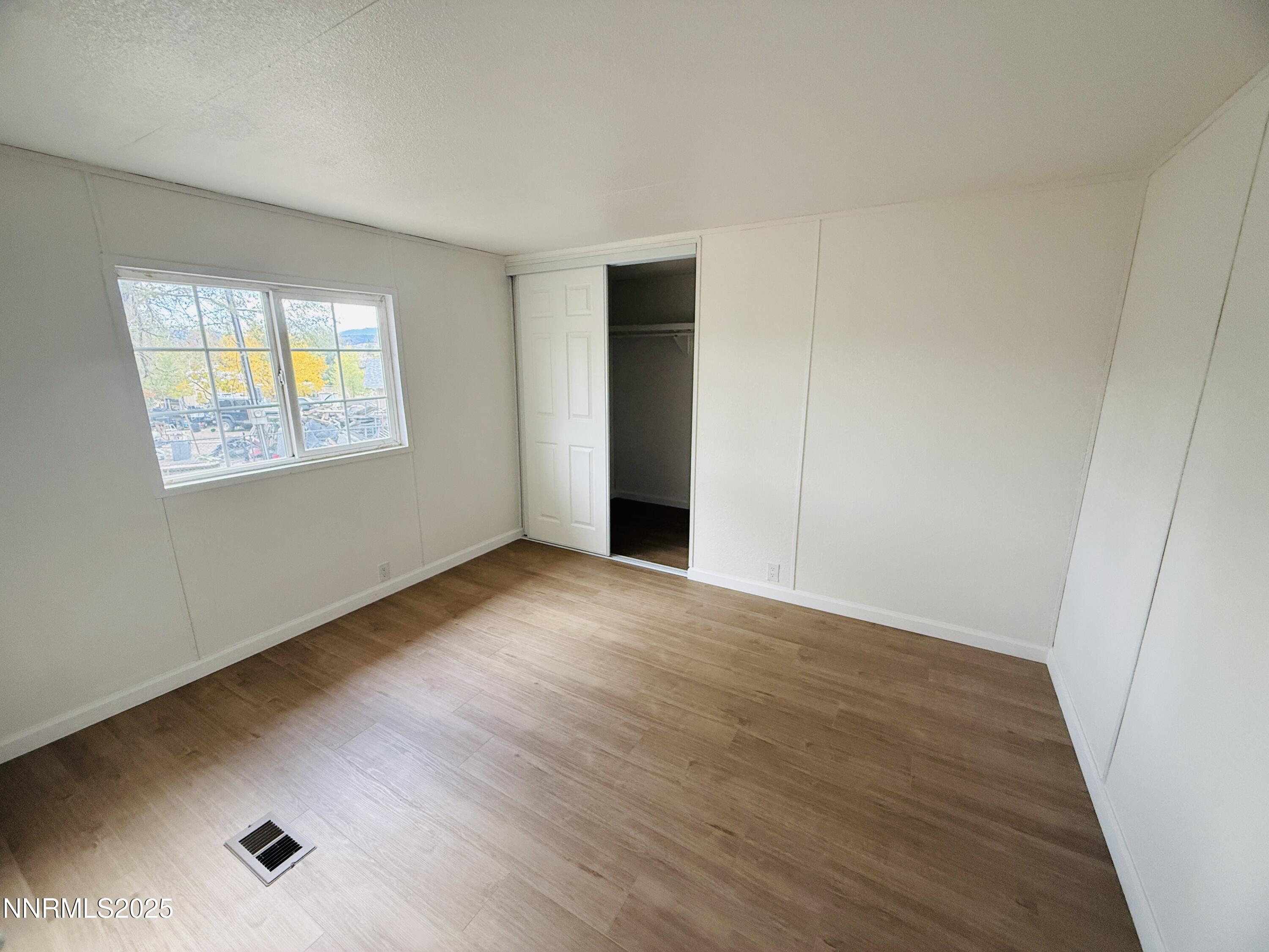 3855 Sandpiper Drive Reno, NV 89508 - Photo 13 of 28 a view of an empty room with wooden floor and a window