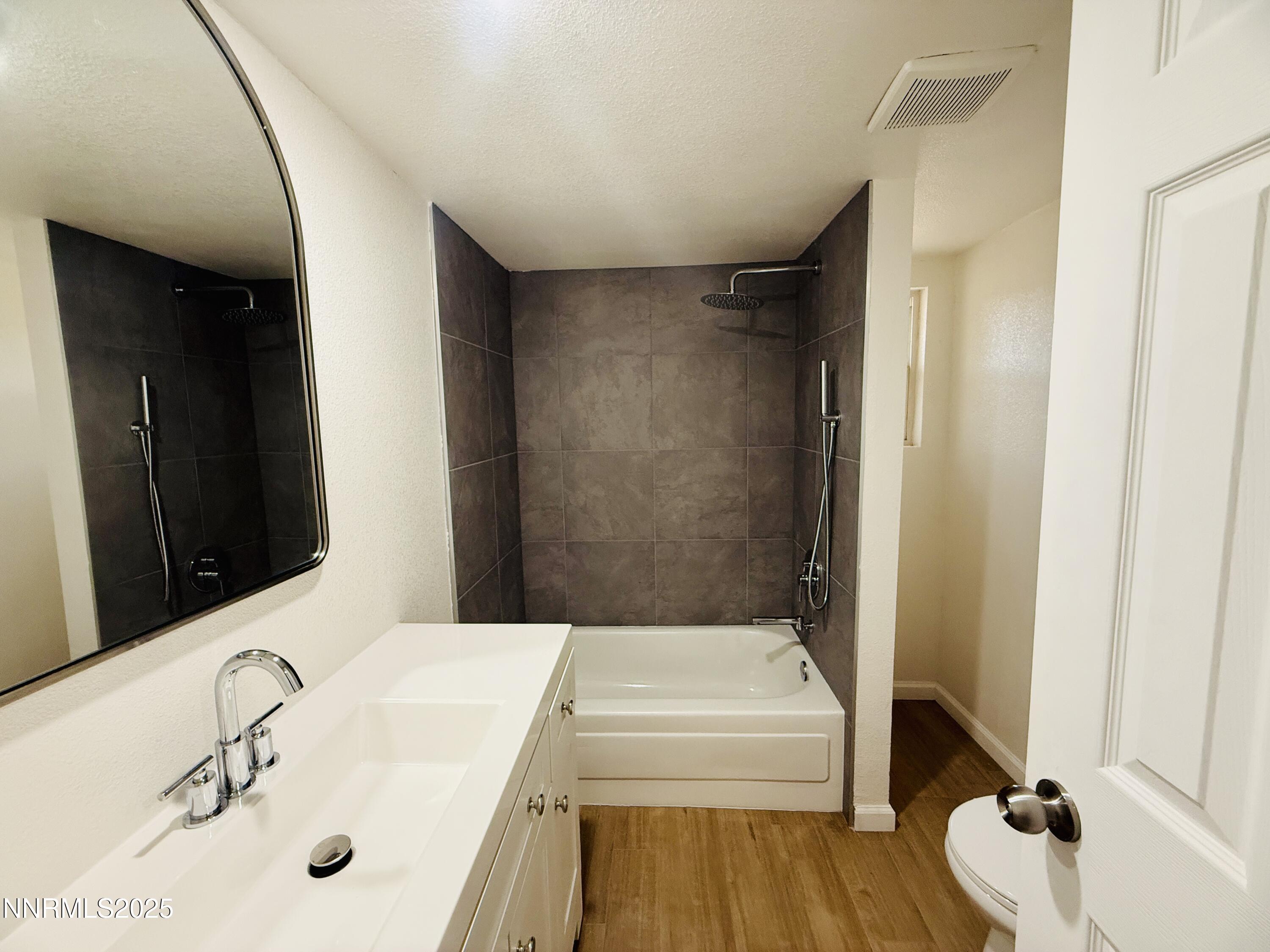 3855 Sandpiper Drive Reno, NV 89508 - Photo 17 of 28 a bathroom with a sink and a mirror