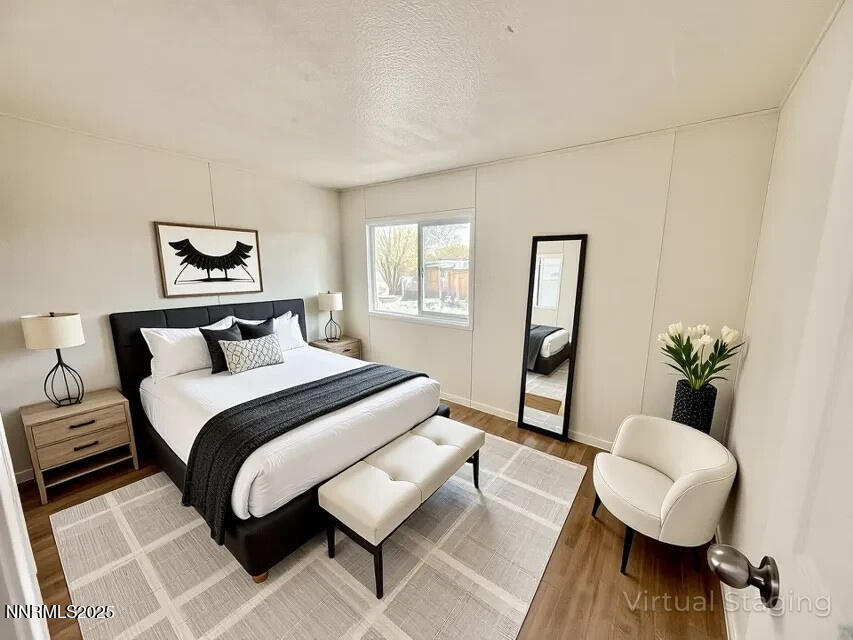 3855 Sandpiper Drive Reno, NV 89508 - Photo 23 of 28 a bedroom with a bed and wooden floor