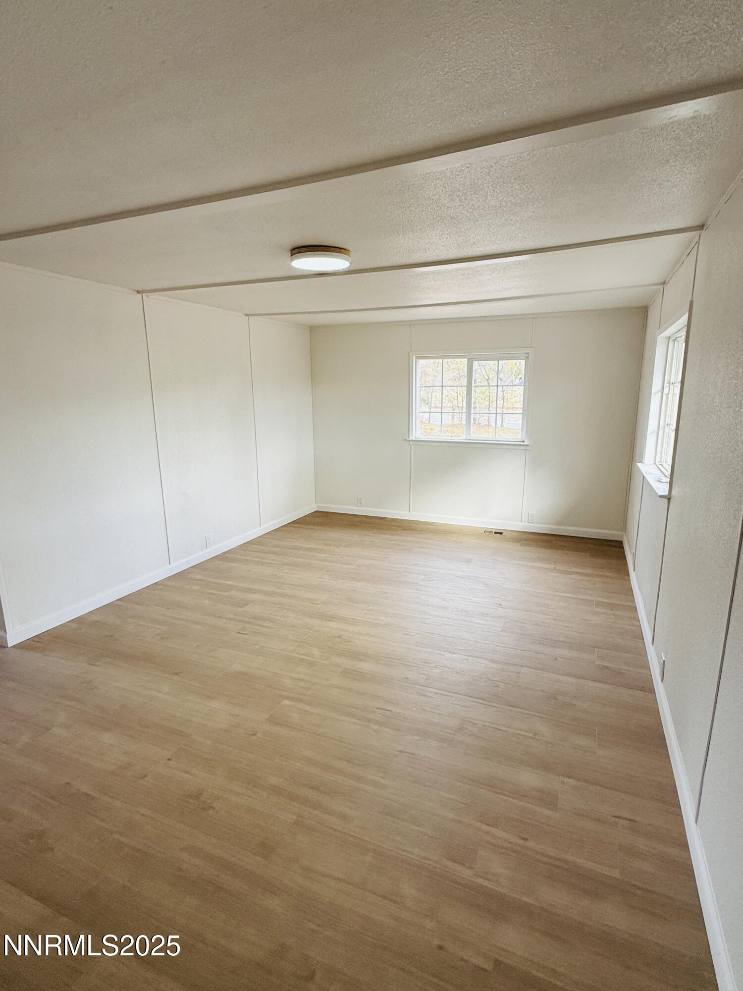 3855 Sandpiper Drive Reno, NV 89508 - Photo 3 of 28 a view of empty room with window and wooden floor