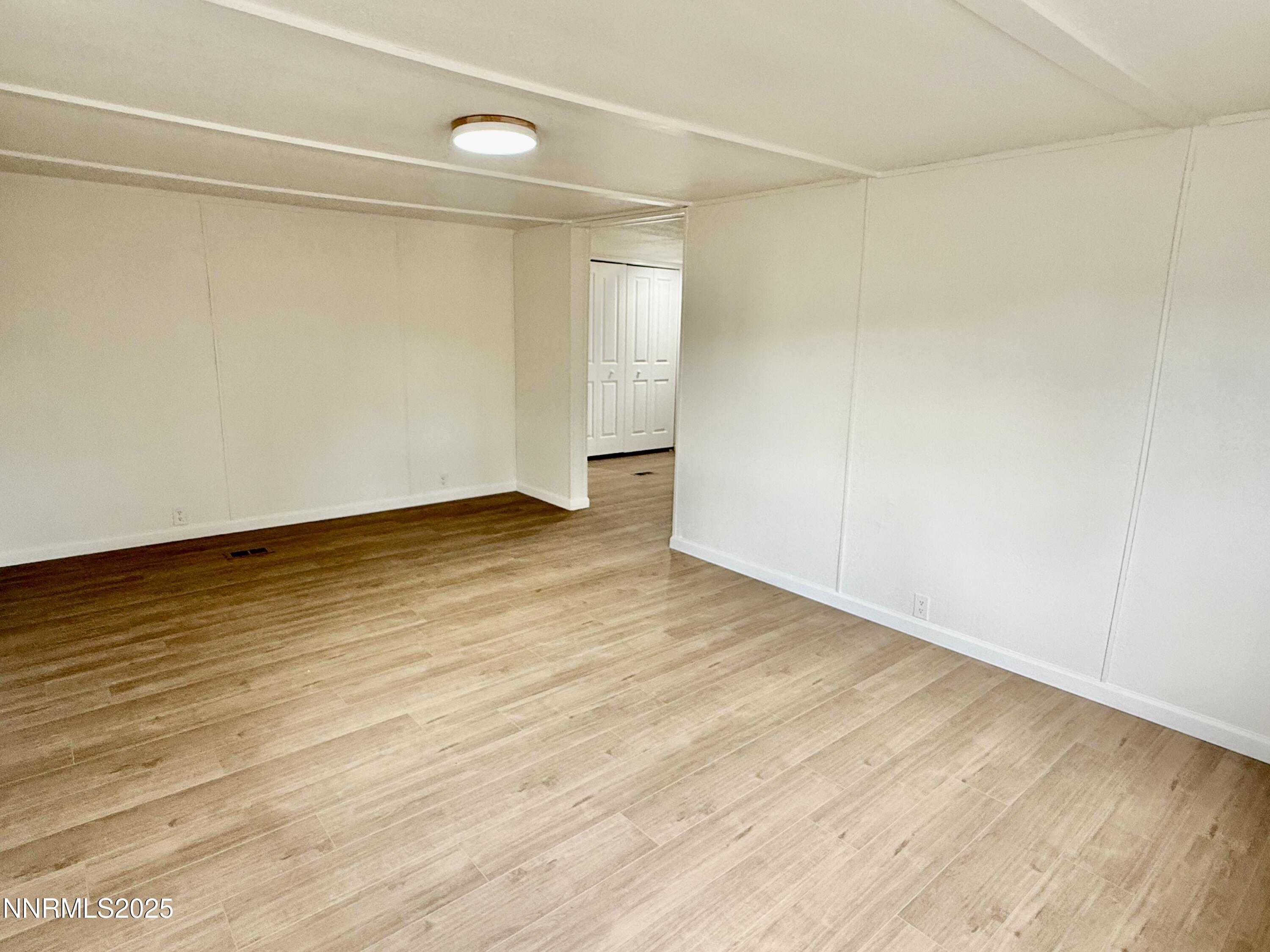 3855 Sandpiper Drive Reno, NV 89508 - Photo 7 of 28 a view of an empty room with wooden floor