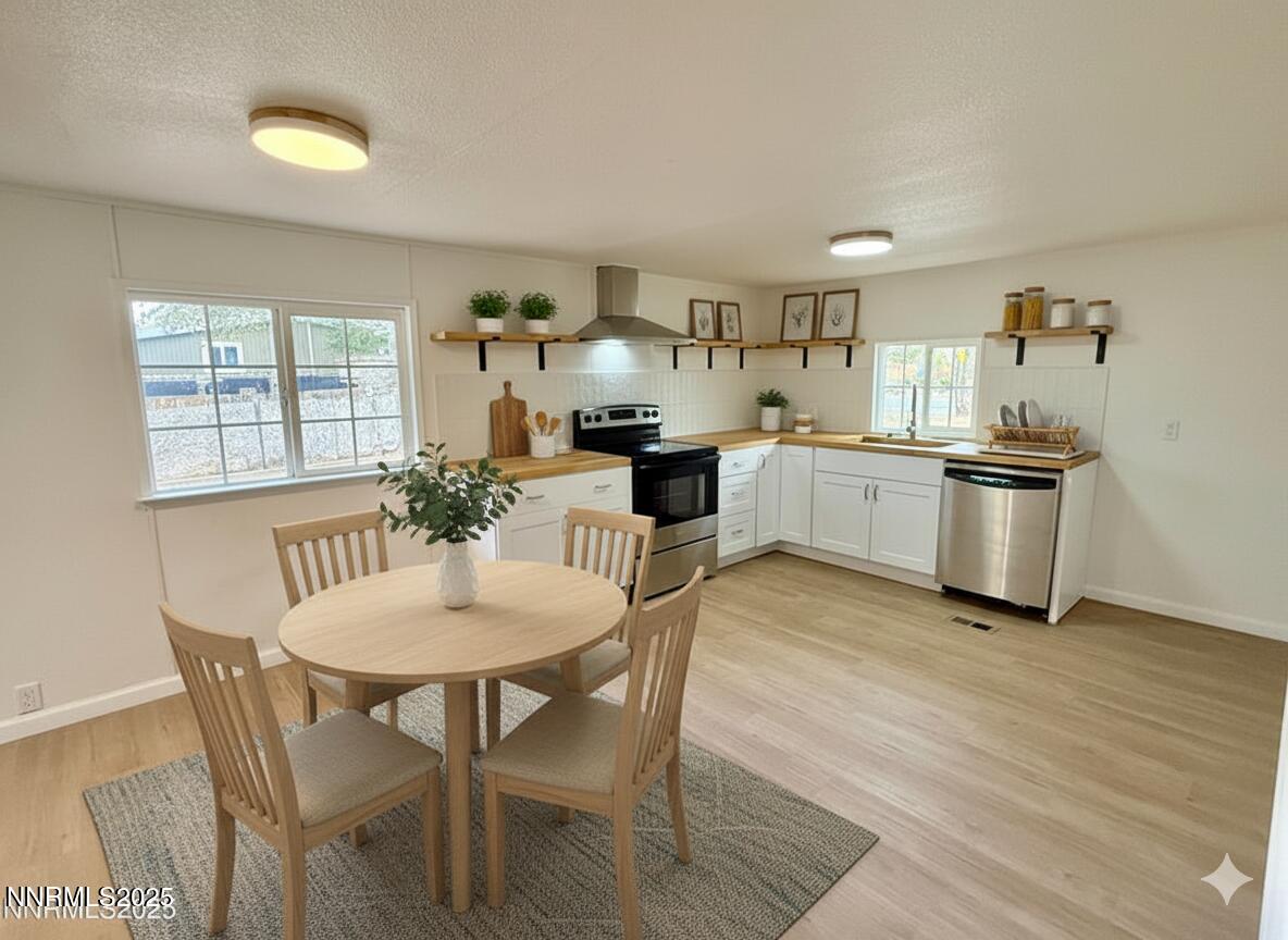 3855 Sandpiper Drive Reno, NV 89508 - Photo 9 of 28 a kitchen with granite countertop stainless steel appliances a dining table and chairs