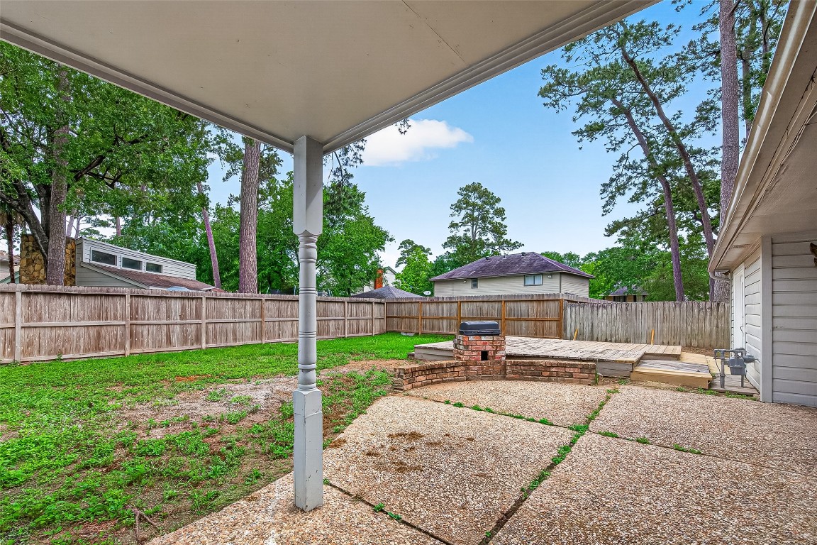 4230 Annawood Circle Spring, TX 77388 - Photo 13 of 50 a patio with a table and chairs under an umbrella
