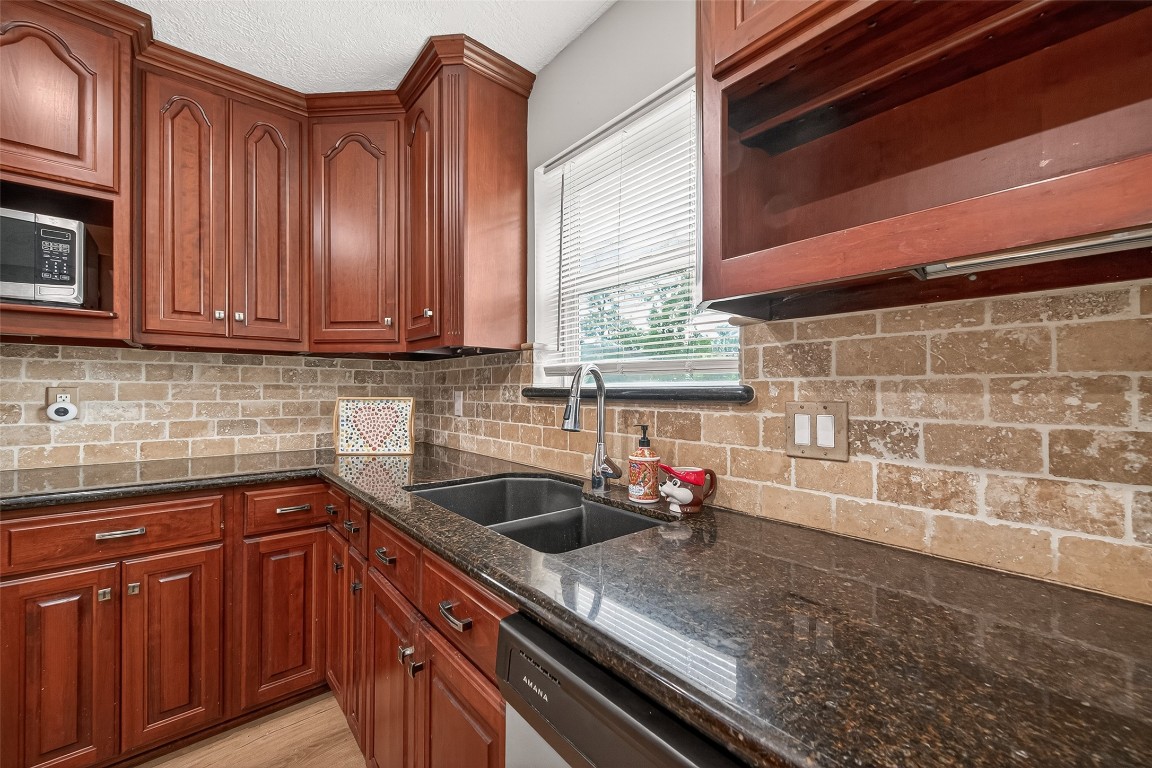 4230 Annawood Circle Spring, TX 77388 - Photo 33 of 50 a kitchen with granite countertop a sink cabinets and window