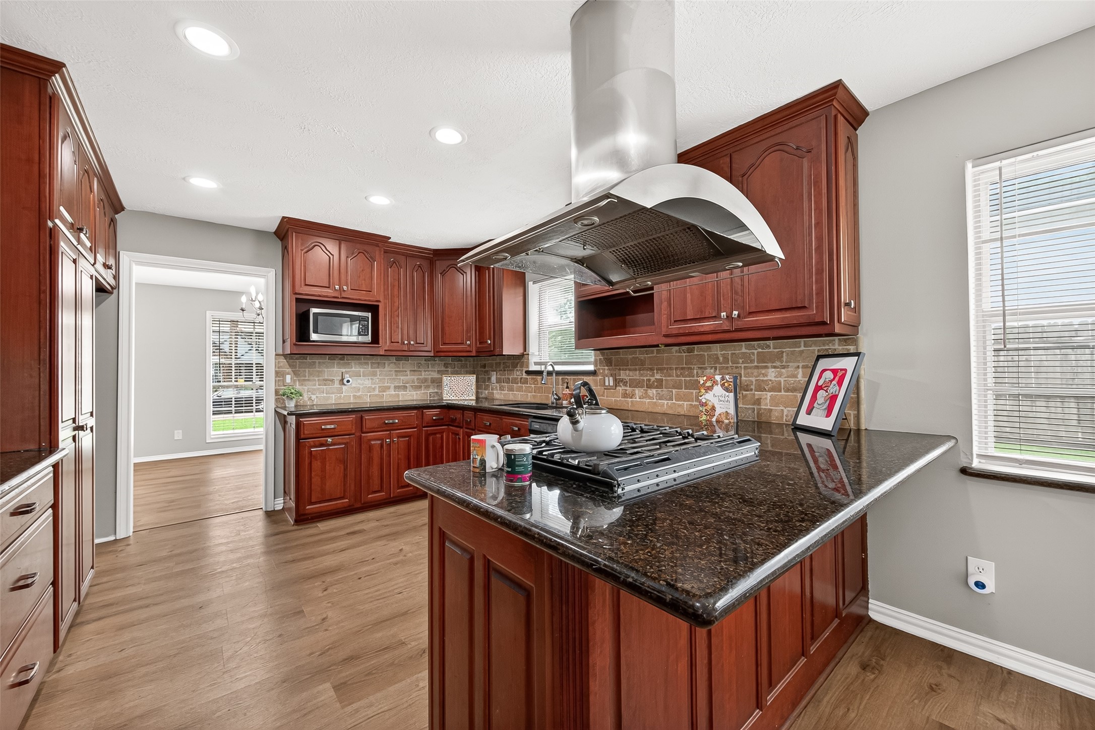 4230 Annawood Circle Spring, TX 77388 - Photo 35 of 50 a kitchen with stainless steel appliances granite countertop a sink a stove and a wooden floors