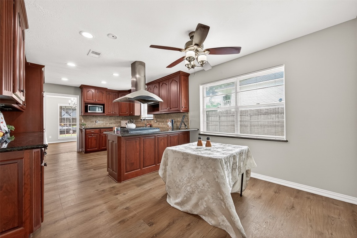4230 Annawood Circle Spring, TX 77388 - Photo 36 of 50 a kitchen with a table chairs refrigerator and microwave