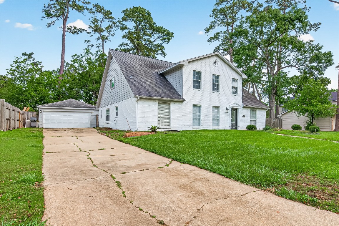 4230 Annawood Circle Spring, TX 77388 - Photo 47 of 50 a view of a white house with a small yard plants and a large tree