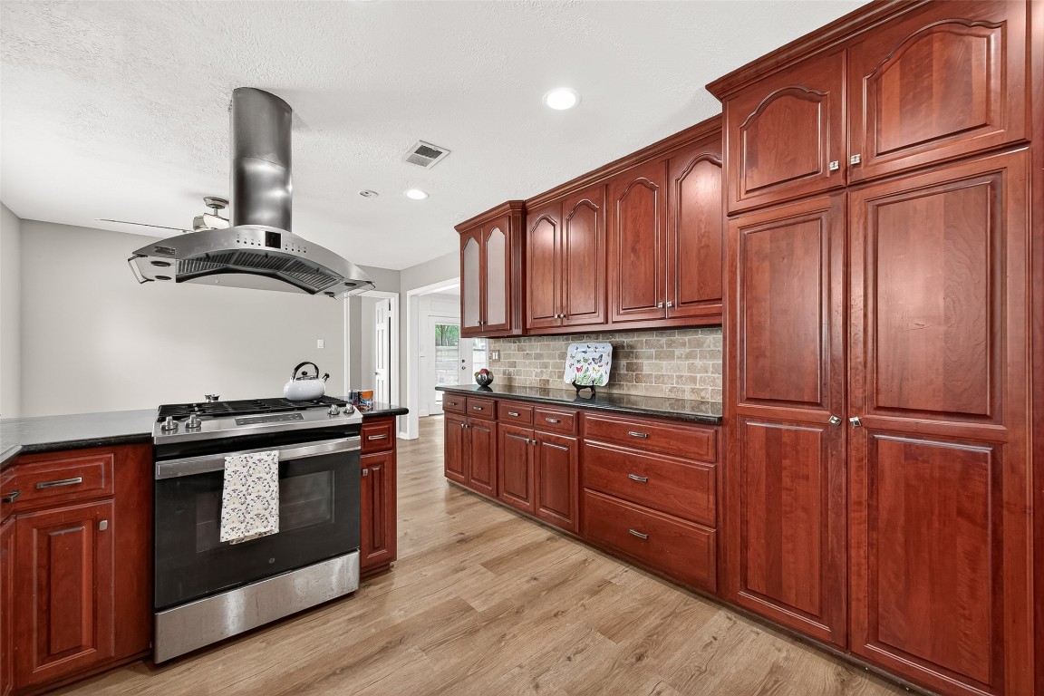 4230 Annawood Circle Spring, TX 77388 - Photo 5 of 50 a kitchen with stainless steel appliances granite countertop a stove a refrigerator and wooden cabinets