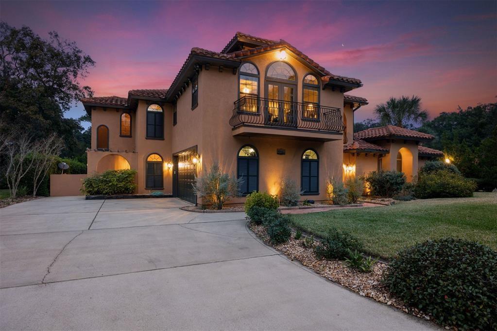 a view of a brick house with a yard