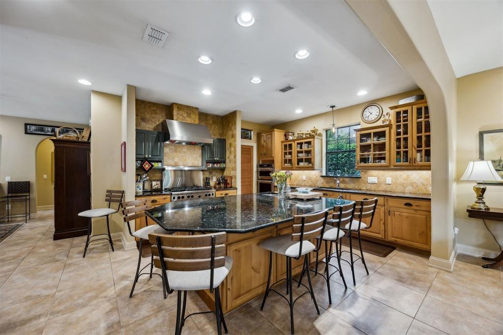 96022 Heath Point Lane Fernandina Beach, FL 32034 - Photo 14 of 39 a kitchen with stainless steel appliances kitchen island granite countertop a table and chairs