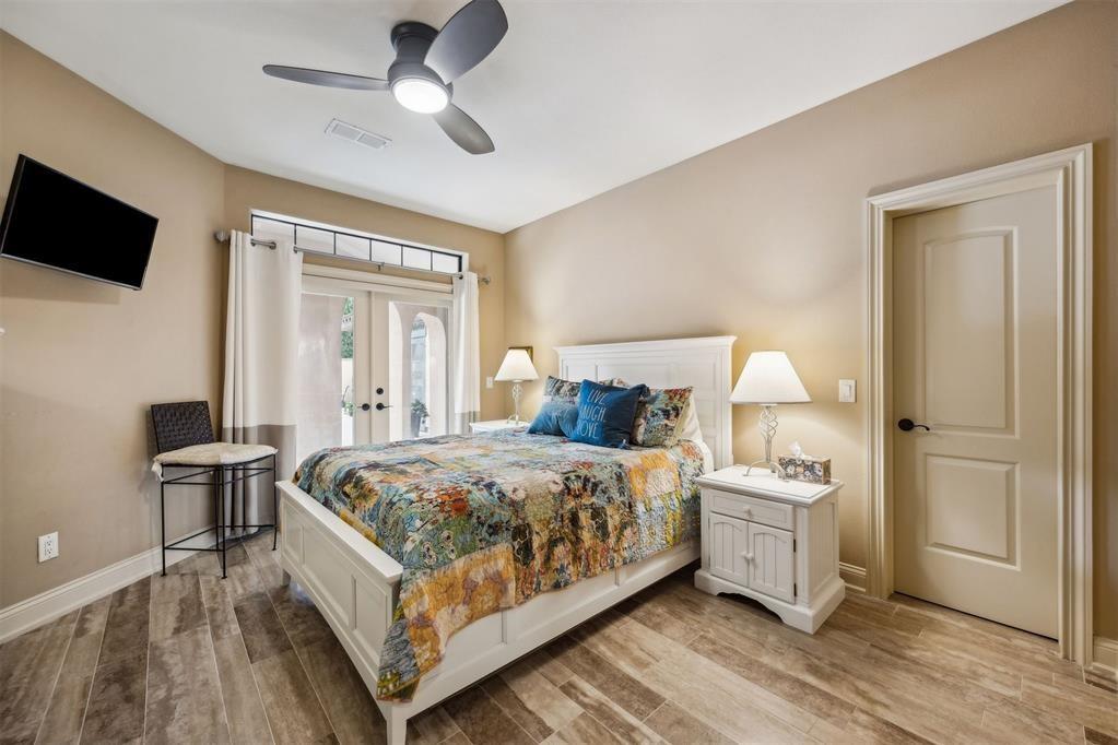 96022 Heath Point Lane Fernandina Beach, FL 32034 - Photo 25 of 39 a bedroom with a bed and a flat tv screen on dresser