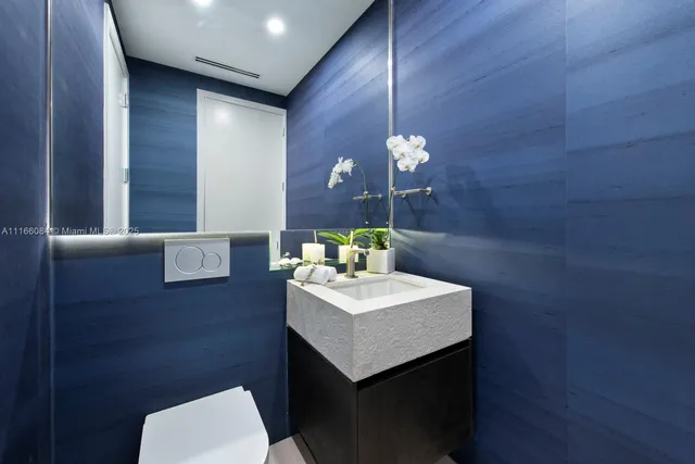 a bathroom with a sink a toilet and mirror