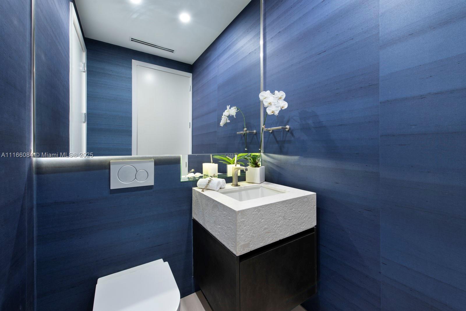 100 South Pointe Drive, Unit 908 Miami Beach, FL 33139 - Photo 14 of 29 a bathroom with a sink a toilet and mirror