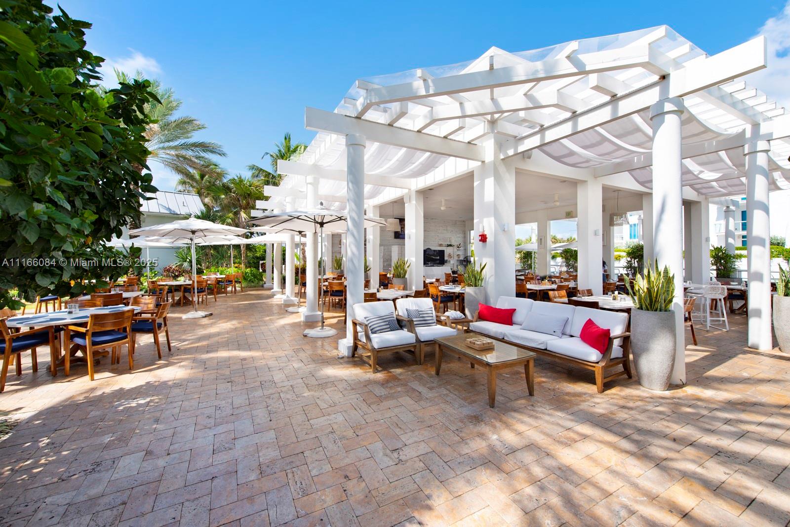 100 South Pointe Drive, Unit 908 Miami Beach, FL 33139 - Photo 22 of 29 a view of a patio with a table and chairs under an umbrella