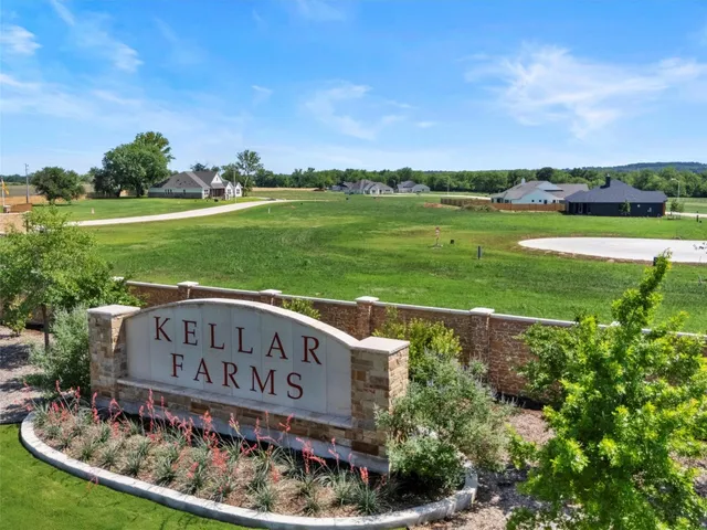 a view of a park with a big yard and large trees