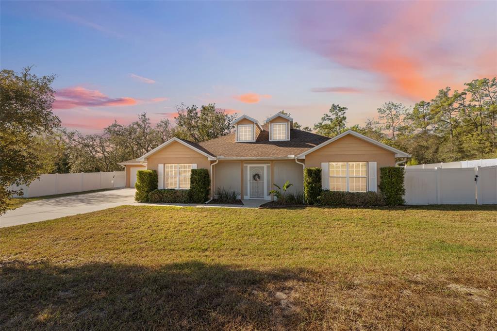 11006 Canary Avenue Weeki Wachee, FL 34613 - Photo 1 of 1 a front view of a house with a yard