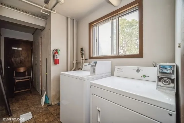a view of washer and dryer with bathroom view