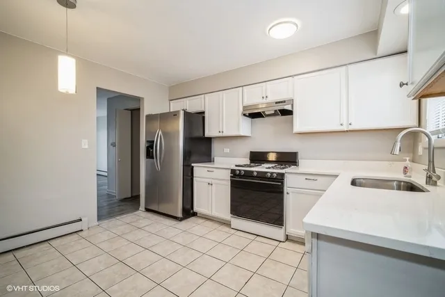 a kitchen with a sink cabinets and stainless steel appliances