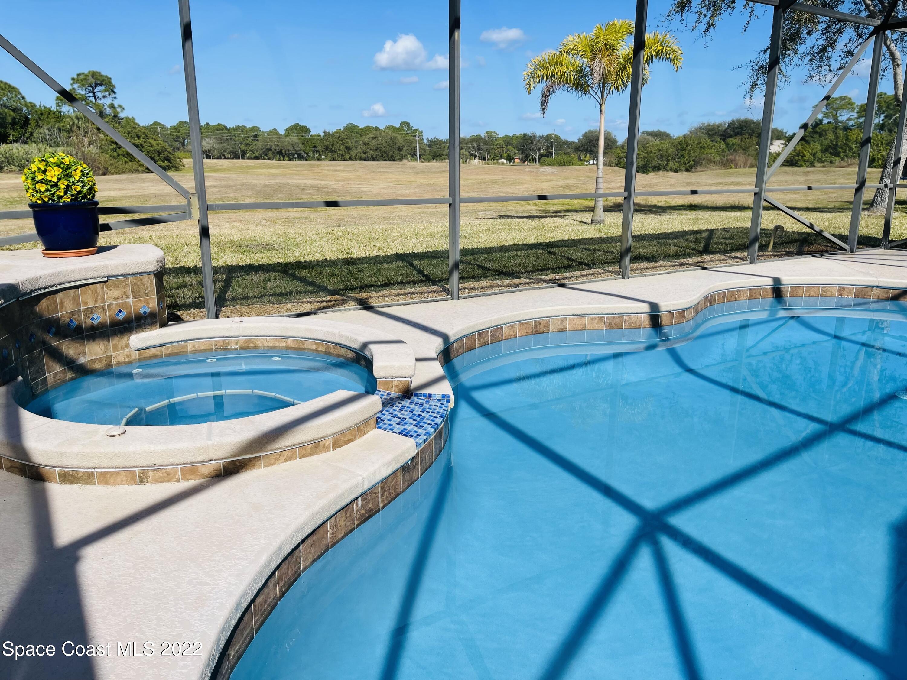 1836 Windbrook Drive Palm Bay, FL 32909 - Photo 36 of 41 a view of a swimming pool with a table and chairs