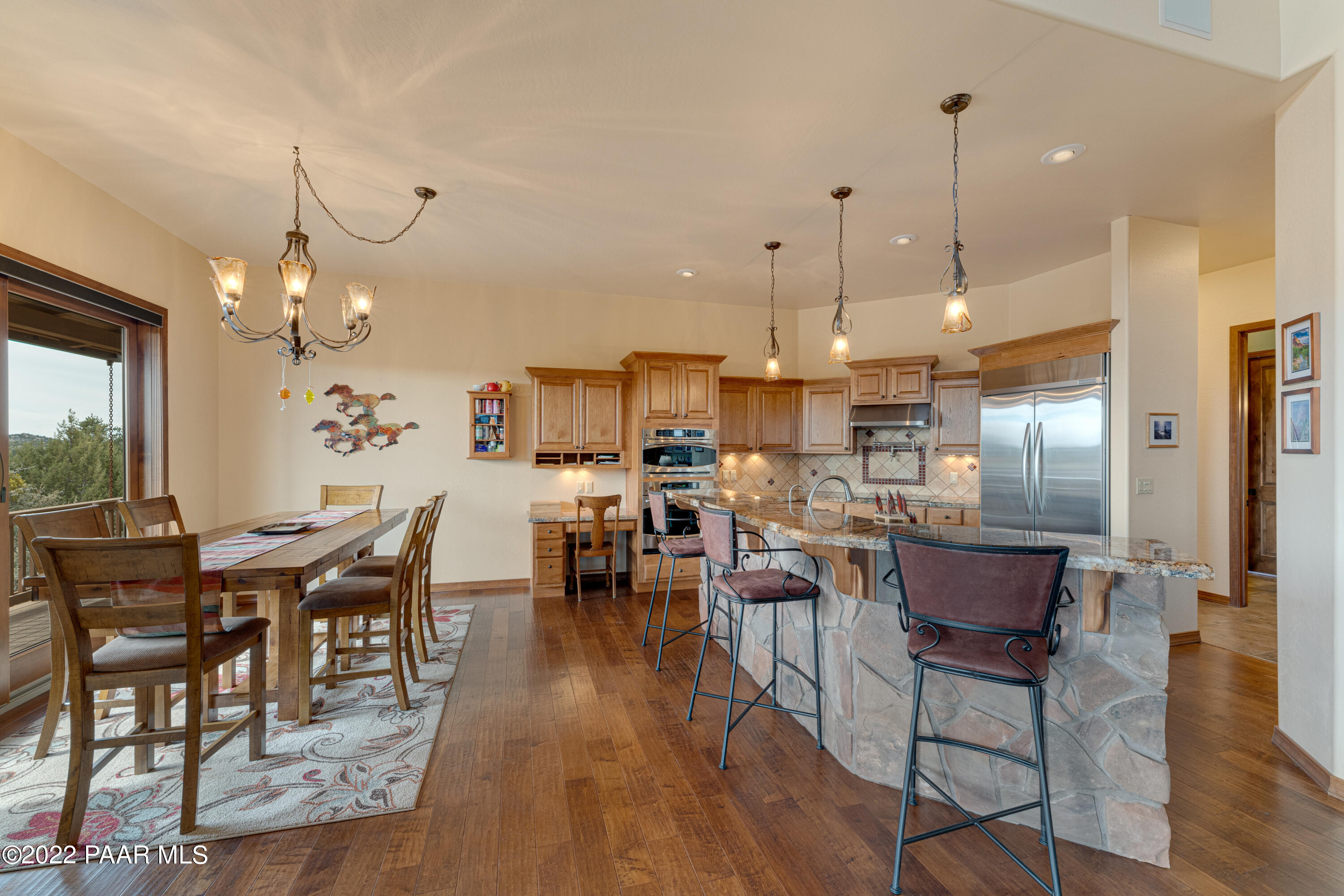 5695 West Three Forks Road Prescott, AZ 86305 - Photo 12 of 48 a view of a dining room and livingroom with furniture wooden floor kitchen chandelier