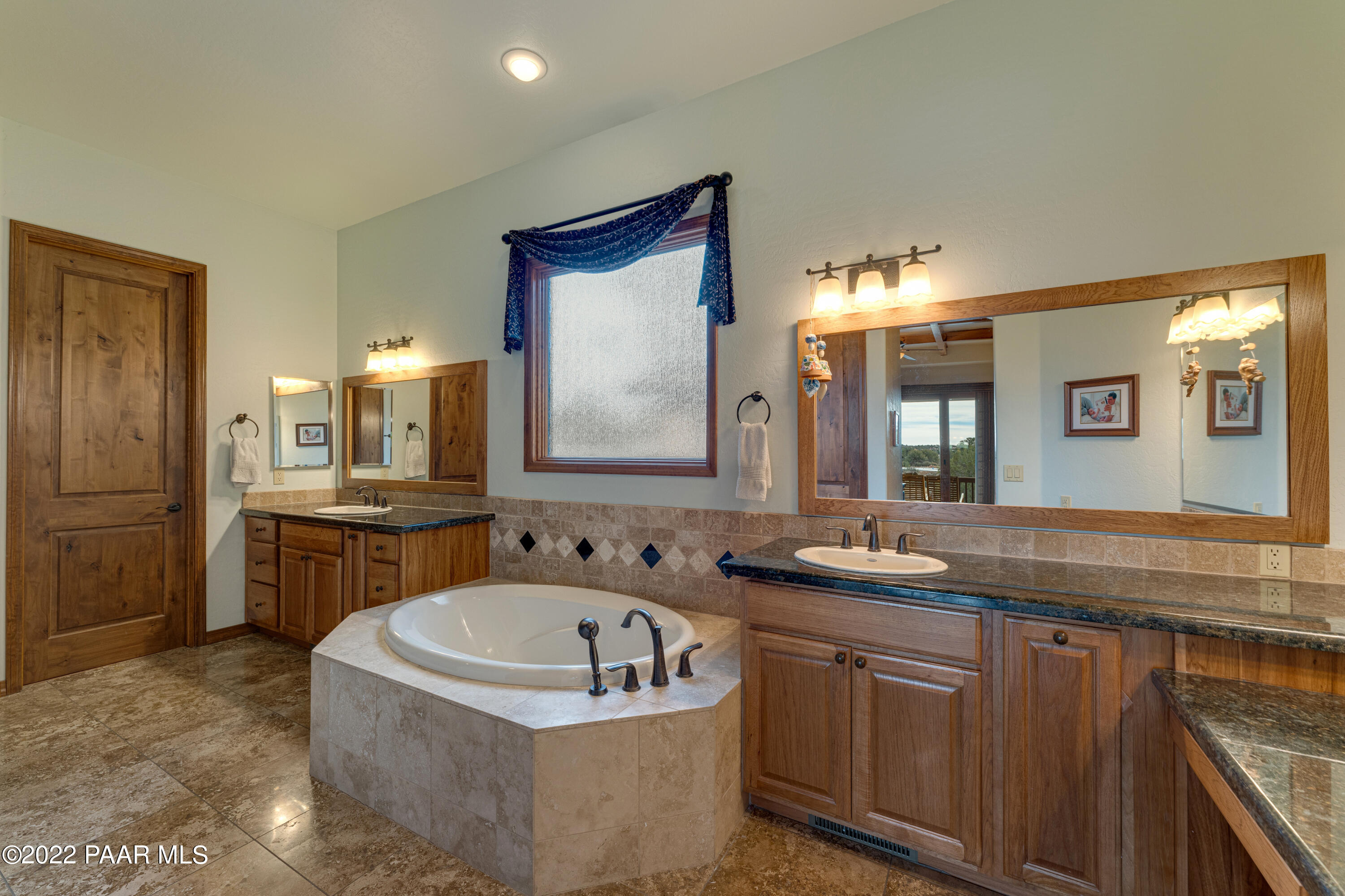 5695 West Three Forks Road Prescott, AZ 86305 - Photo 22 of 48 a bathroom with a granite countertop sink and a mirror