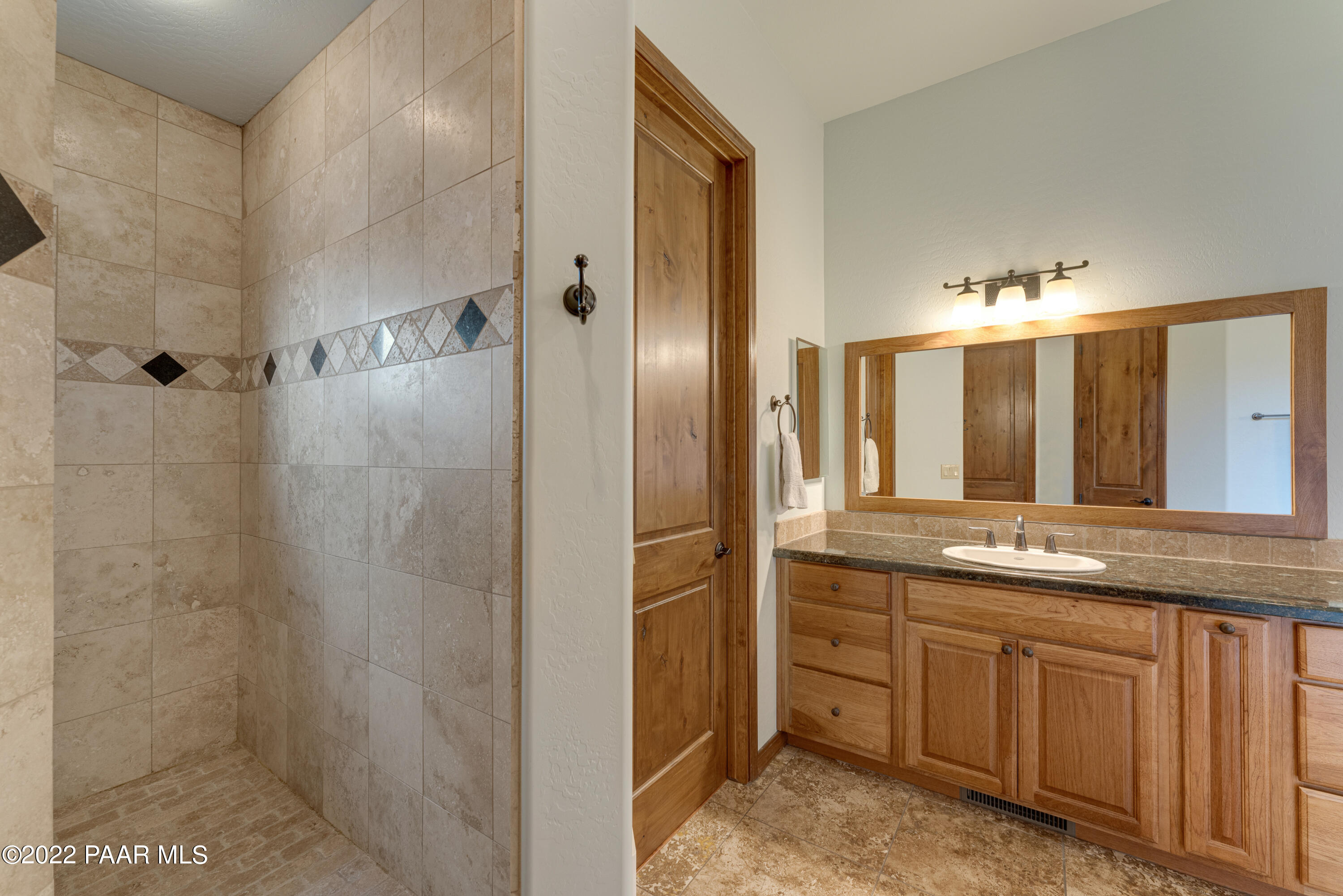 5695 West Three Forks Road Prescott, AZ 86305 - Photo 24 of 48 a bathroom with a double vanity sink and a mirror