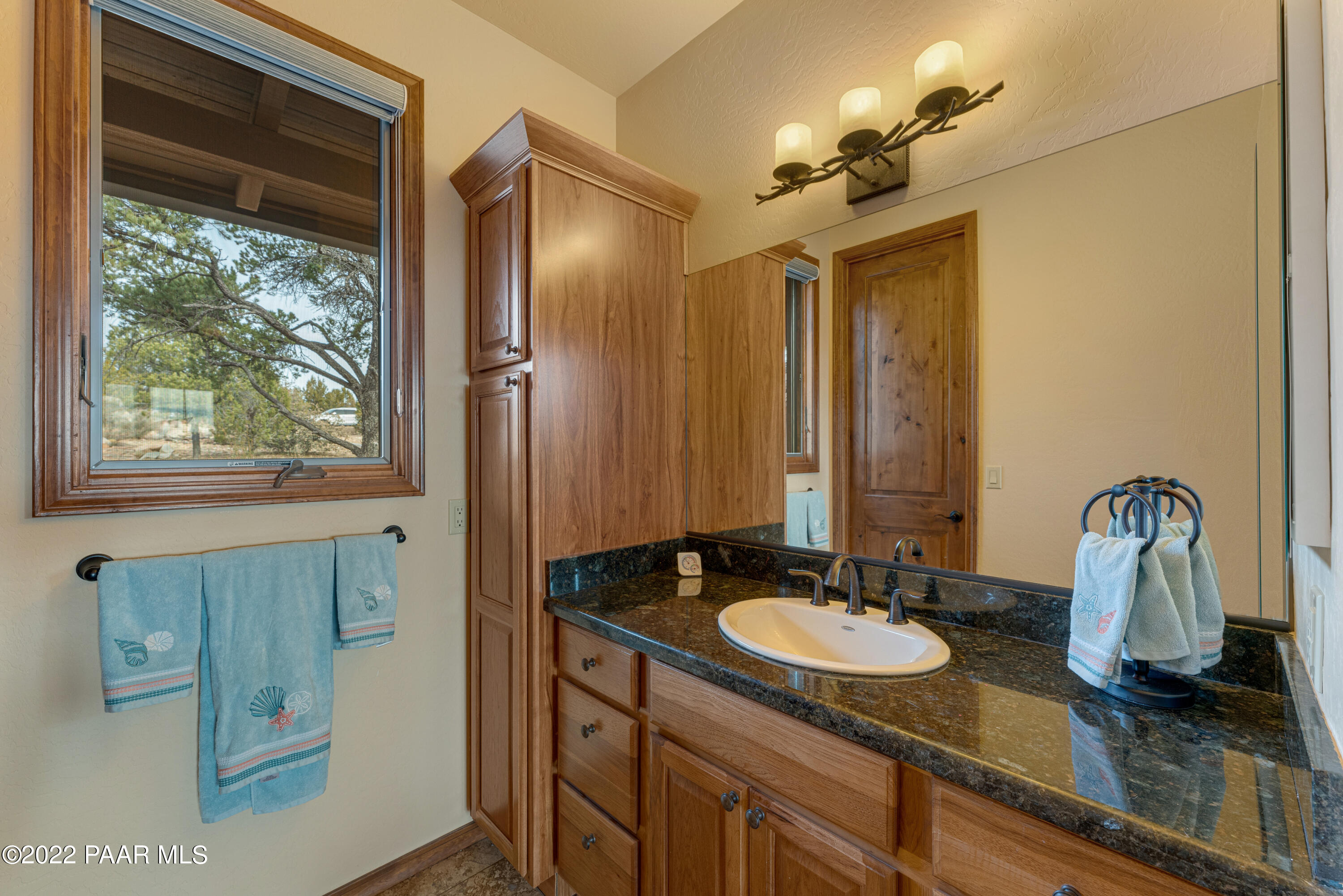 5695 West Three Forks Road Prescott, AZ 86305 - Photo 26 of 48 a bathroom with double vanity sink and a mirror