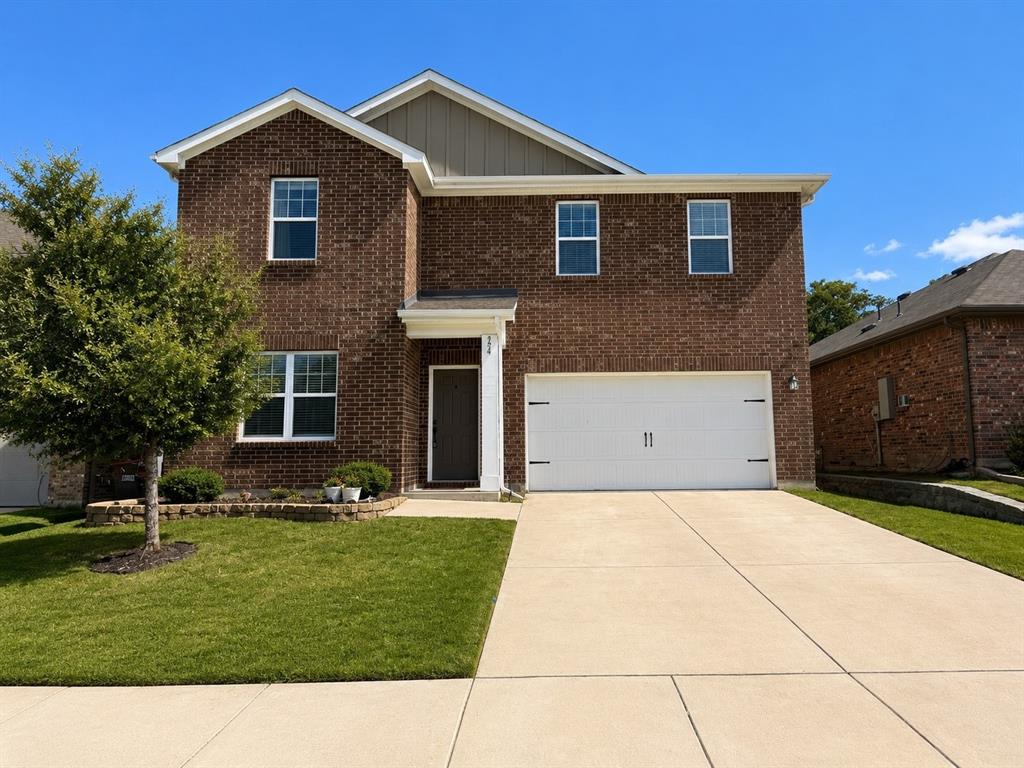 824 Juniper Street Anna, TX 75409 - Photo 1 of 25 Brick facade home featuring a two-car garage, concrete driveway, front yard with mature landscaping, and a covered entry