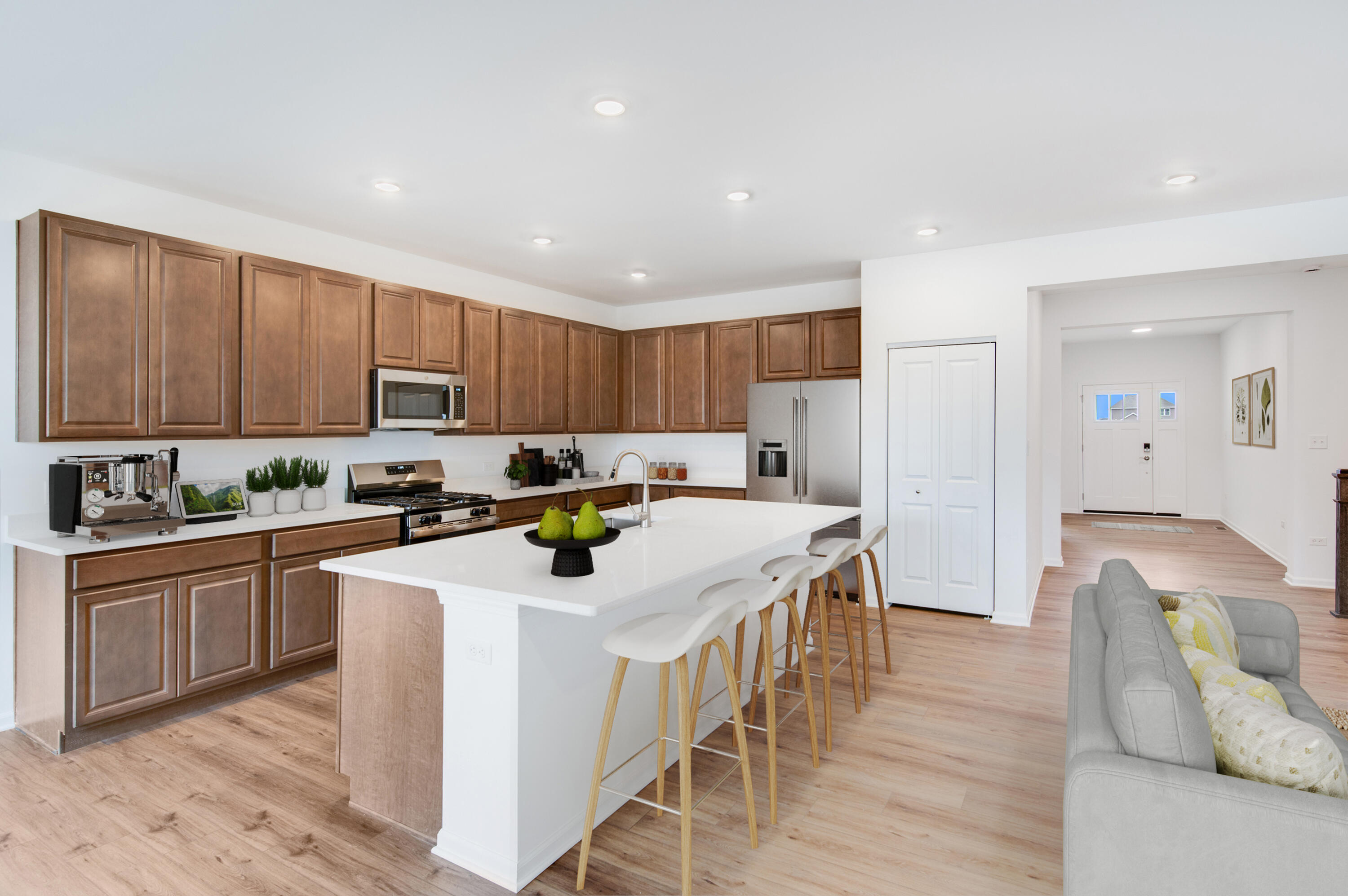 6054 East 112th Place Winfield, IN 46307 - Photo 12 of 29 a kitchen with stainless steel appliances granite countertop a table chairs sink refrigerator and cabinets