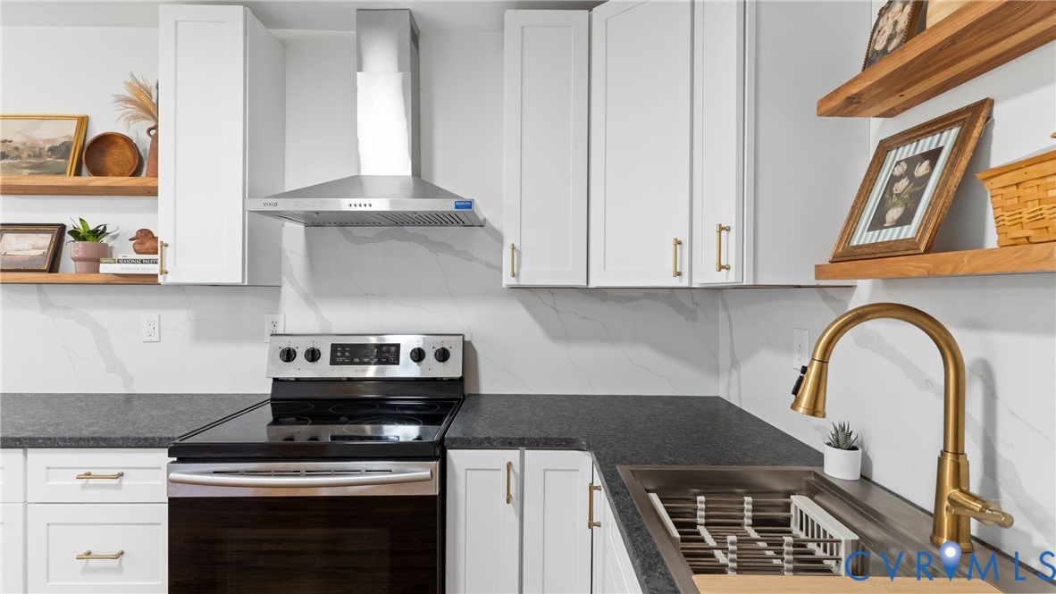 11550 Lunenburg County Road Keysville, VA 23947 - Photo 8 of 48 White cabinetry with brass-finish hardware, dark c