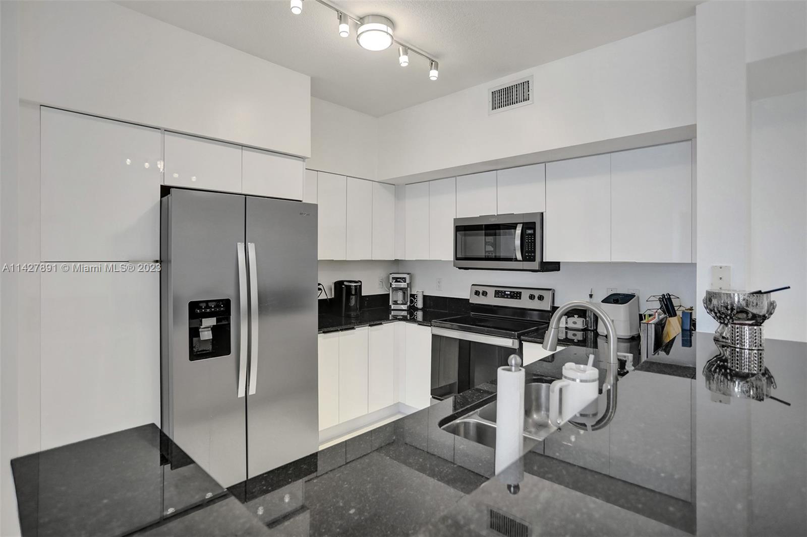 233 South Federal Highway, Unit 605 Boca Raton, FL 33432 - Photo 13 of 41 a kitchen with stainless steel appliances a refrigerator and a stove top oven