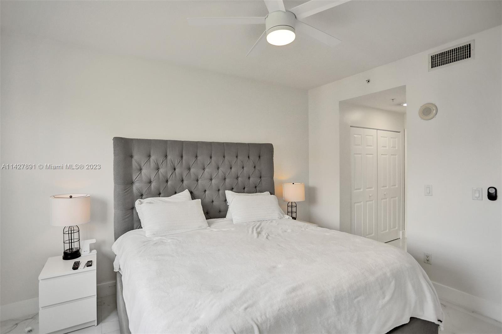 233 South Federal Highway, Unit 605 Boca Raton, FL 33432 - Photo 18 of 41 a bedroom with a bed and a night stand