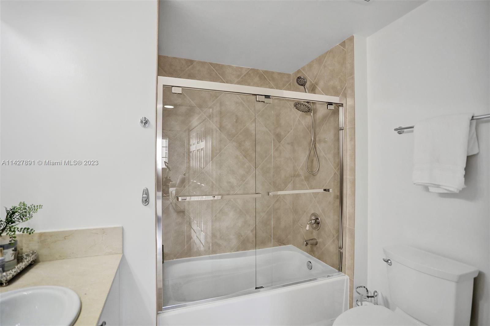 233 South Federal Highway, Unit 605 Boca Raton, FL 33432 - Photo 27 of 41 a bathroom with a granite countertop bathtub shower and toilet