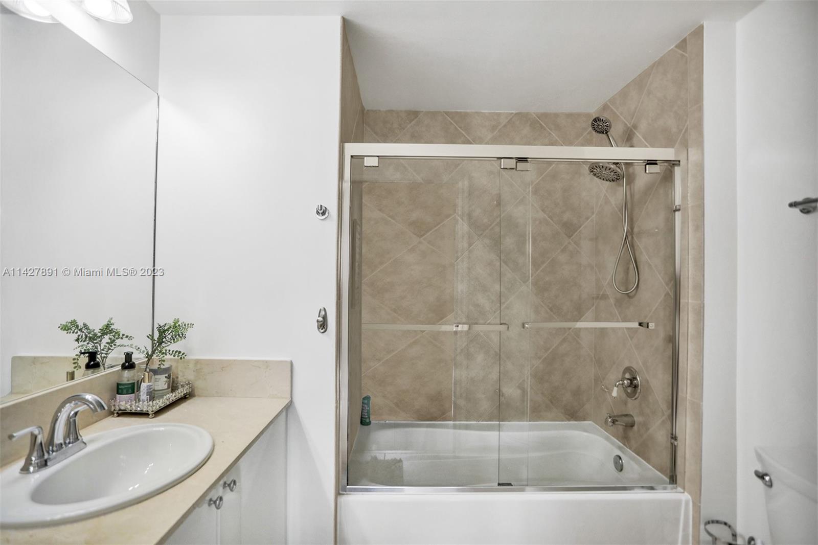 233 South Federal Highway, Unit 605 Boca Raton, FL 33432 - Photo 28 of 41 a bathroom with a granite countertop sink mirror and a bathtub
