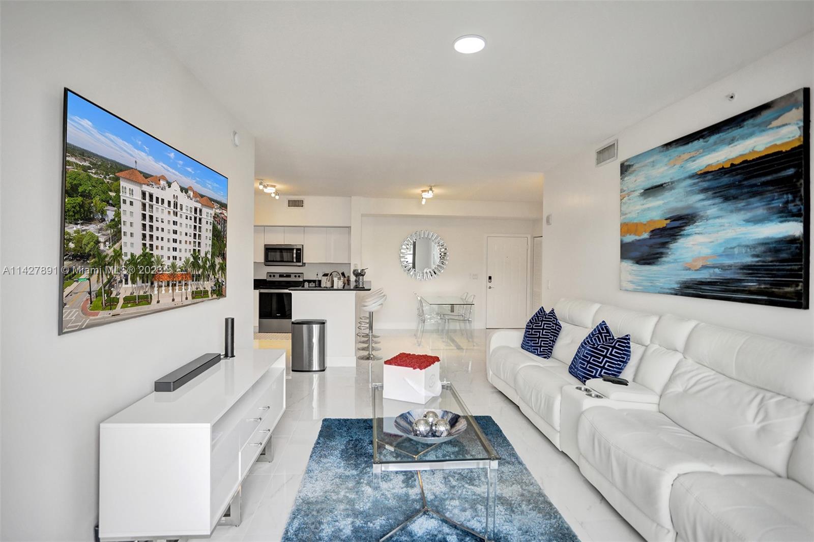 233 South Federal Highway, Unit 605 Boca Raton, FL 33432 - Photo 33 of 41 a living room with furniture and a flat screen tv