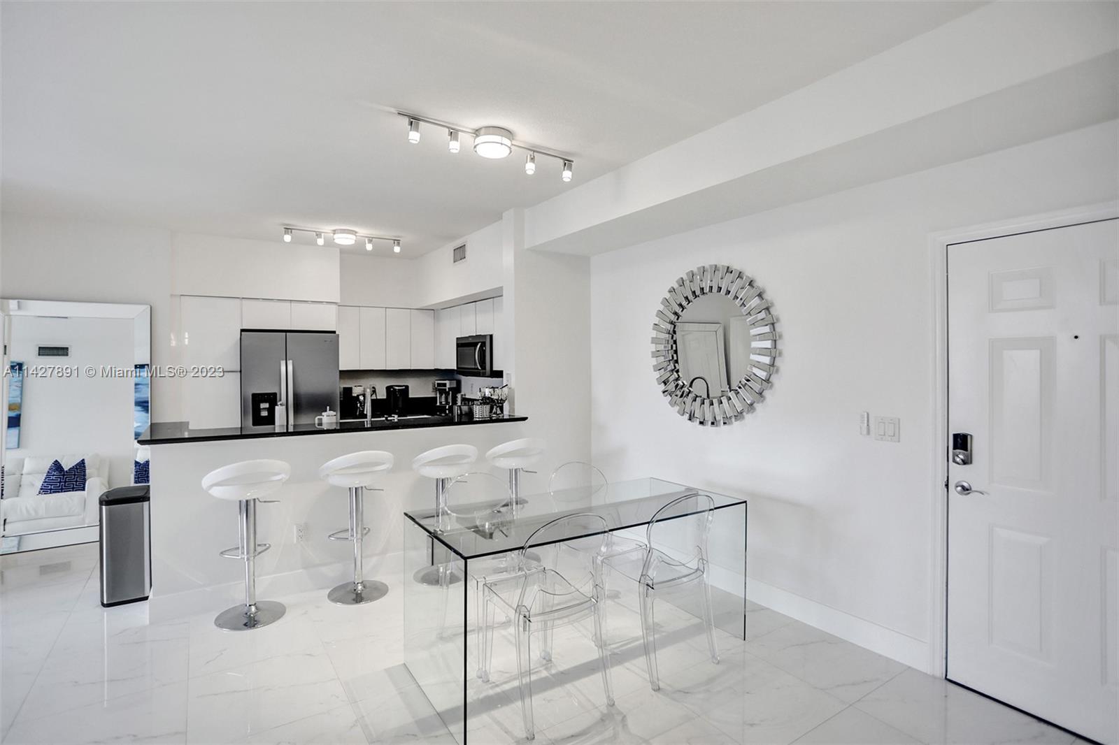 233 South Federal Highway, Unit 605 Boca Raton, FL 33432 - Photo 4 of 41 a kitchen with stainless steel appliances granite countertop a refrigerator and a stove top oven