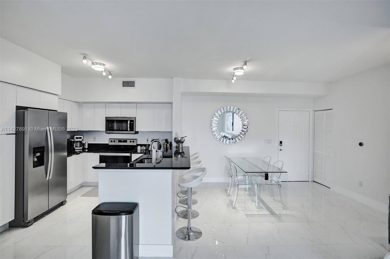 233 South Federal Highway, Unit 605 Boca Raton, FL 33432 - Photo 9 of 41 a living room with stainless steel appliances furniture a refrigerator and a kitchen view