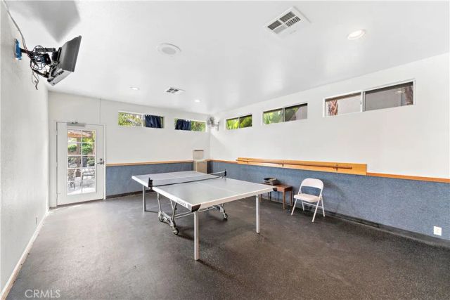 a view of a patio with couches chairs and wooden floor