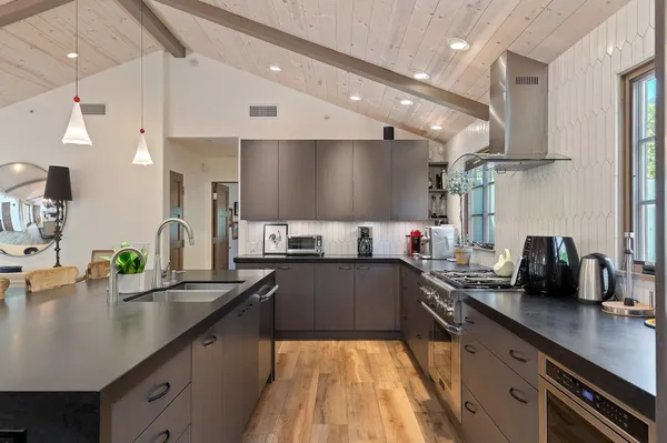 a large kitchen with lots of counter space and stainless steel appliances