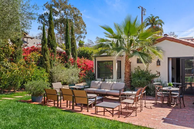 a view of a house with backyard sitting area and garden