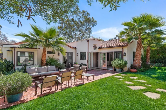 a view of a house with a backyard and a patio