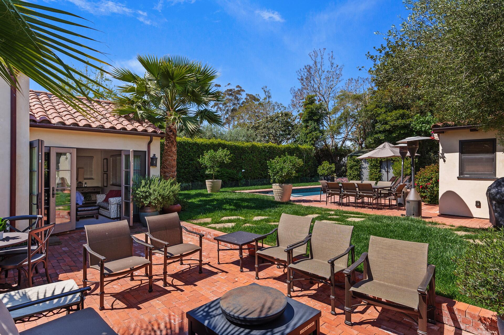 Undisclosed Address Montecito, CA 93108 - Photo 14 of 33 a view of a patio with table and chairs potted plants and large tree