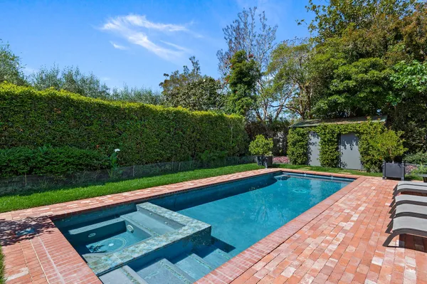a view of a pool with a yard