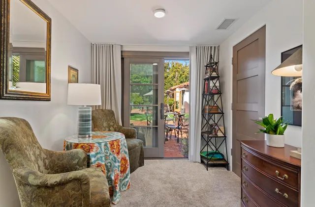 a living room with furniture and a potted plant